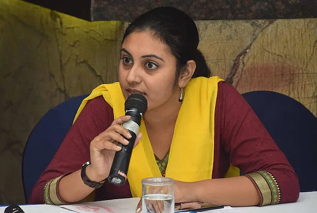 Young woman speaking into a microphone