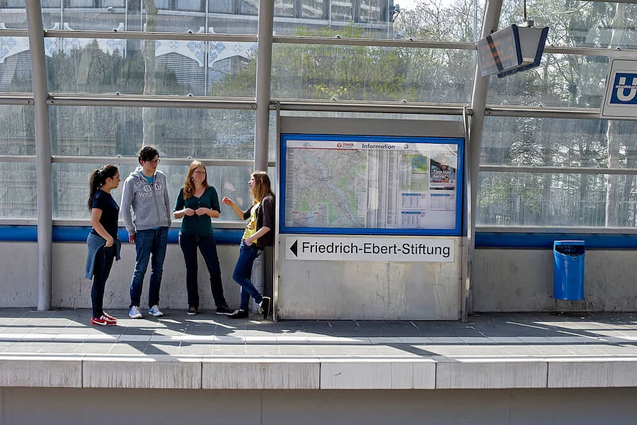 Young people standing at a underground station